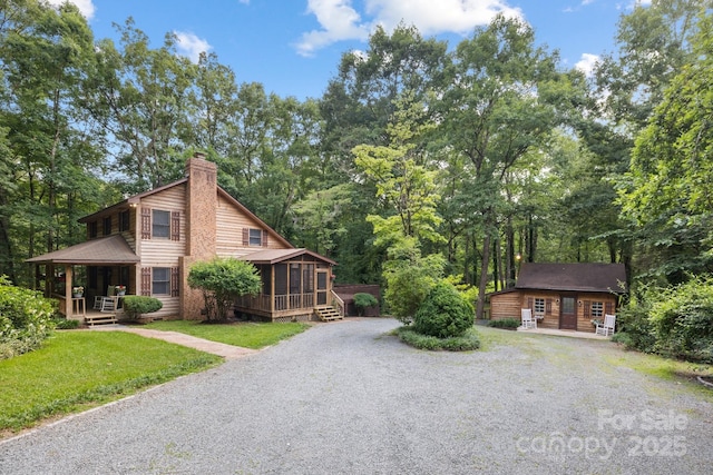 715 White Oaks Cir, Monroe, NC 28110 - view of side of property with driveway, a sunroom, a chimney, and an outdoor structure