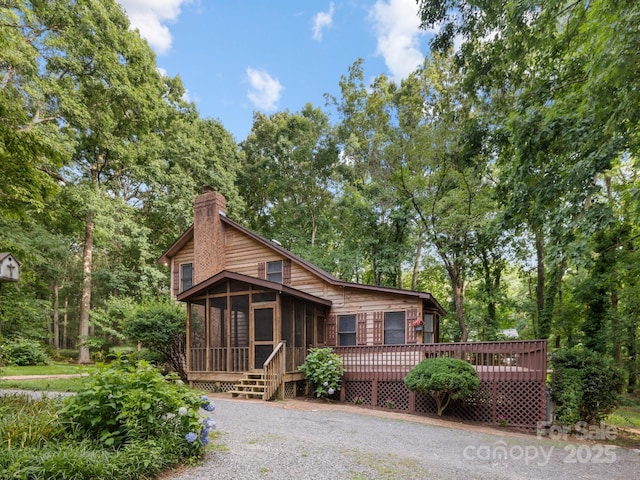 715 White Oaks Cir, Monroe, NC 28110 - chalet / cabin featuring a sunroom, a chimney, and a deck