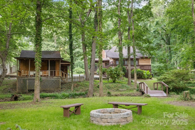 715 White Oaks Cir, Monroe, NC 28110 - view of grassy yard featuring a fire pit, a wooden deck, a sunroom, and stairs