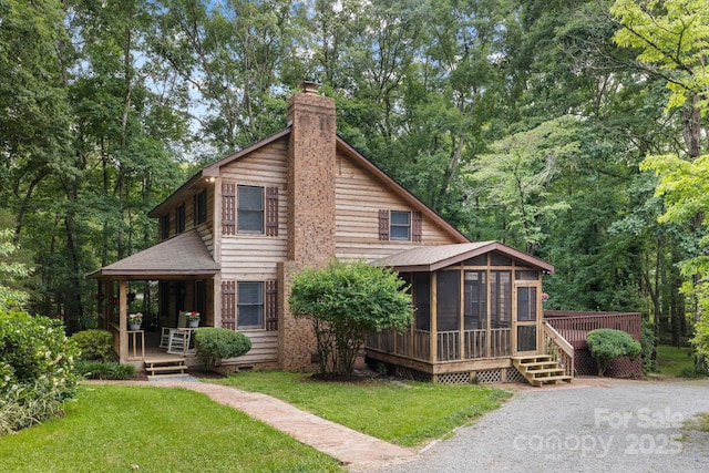 715 White Oaks Cir, Monroe, NC 28110 - rear view of property featuring a sunroom, a chimney, and a lawn