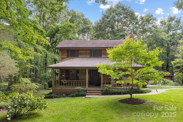 715 White Oaks Cir, Monroe, NC 28110 - view of front of property featuring a front lawn, a chimney, and a porch