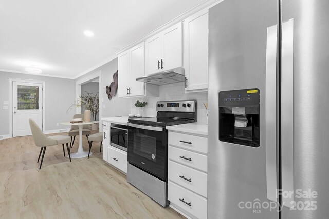 715 White Oaks Cir, Monroe, NC 28110 - kitchen with stainless steel appliances, under cabinet range hood, light wood-type flooring, light countertops, and white cabinetry