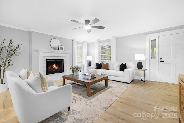715 White Oaks Cir, Monroe, NC 28110 - living area featuring light wood-style floors, ceiling fan, ornamental molding, and a brick fireplace