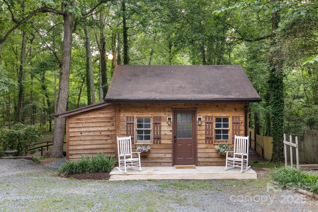 715 White Oaks Cir, Monroe, NC 28110 - view of front of property with roof with shingles, an outdoor structure, and a wooded view