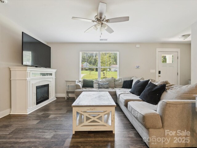 429 Summer Ridge Dr, Stanley, NC 28164 - living room featuring healthy amount of natural light, a ceiling fan, dark wood-style flooring, and a glass covered fireplace