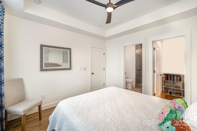 3026 Kalex Ct, Charlotte, NC 28204 - bedroom featuring a raised ceiling, wood finished floors, ensuite bathroom, and ceiling fan