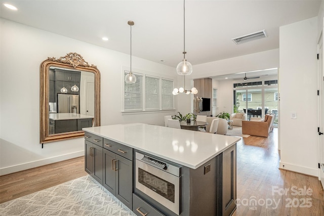 3026 Kalex Ct, Charlotte, NC 28204 - kitchen featuring light wood-style flooring, appliances with stainless steel finishes, light countertops, a ceiling fan, and recessed lighting