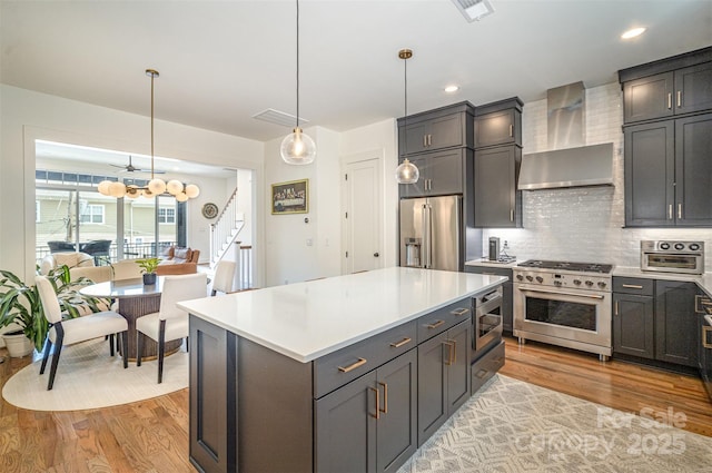 3026 Kalex Ct, Charlotte, NC 28204 - kitchen with high quality appliances, wall chimney range hood, light wood-style flooring, tasteful backsplash, and light countertops