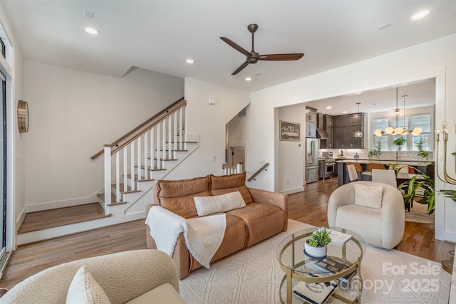 3026 Kalex Ct, Charlotte, NC 28204 - living area featuring wood finished floors, stairway, a chandelier, ceiling fan, and recessed lighting