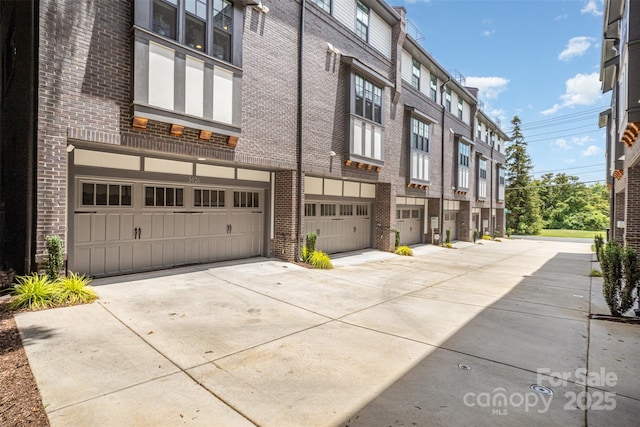 3026 Kalex Ct, Charlotte, NC 28204 - view of building exterior with an attached garage, concrete driveway, and a residential view
