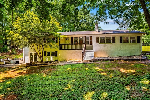 2229 Old Wilkesboro Rd, Statesville, NC 28625 - view of front facade featuring brick siding, a chimney, and a front yard