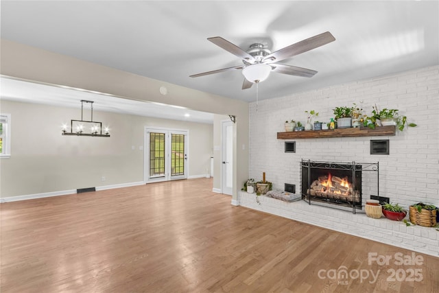 2229 Old Wilkesboro Rd, Statesville, NC 28625 - unfurnished living room with a fireplace, light wood finished floors, a ceiling fan, and baseboards
