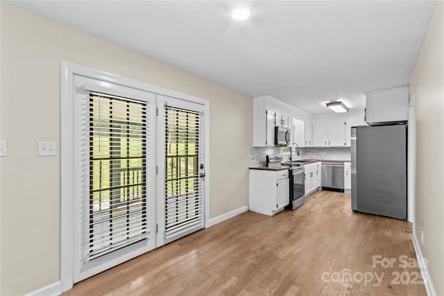 2229 Old Wilkesboro Rd, Statesville, NC 28625 - kitchen with stainless steel appliances, a sink, tasteful backsplash, and baseboards