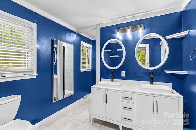 2229 Old Wilkesboro Rd, Statesville, NC 28625 - full bathroom with double vanity, toilet, and baseboards