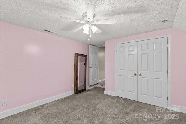 2229 Old Wilkesboro Rd, Statesville, NC 28625 - unfurnished bedroom featuring carpet flooring, a textured ceiling, baseboards, a closet, and ceiling fan
