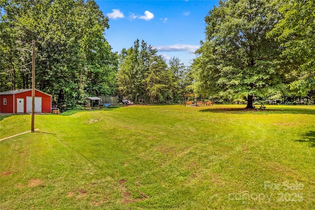 2229 Old Wilkesboro Rd, Statesville, NC 28625 - view of grassy yard with a garage, an outbuilding, and a playground