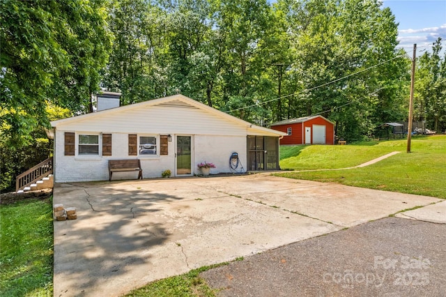 2229 Old Wilkesboro Rd, Statesville, NC 28625 - view of front facade with a chimney, a front yard, brick siding, and driveway