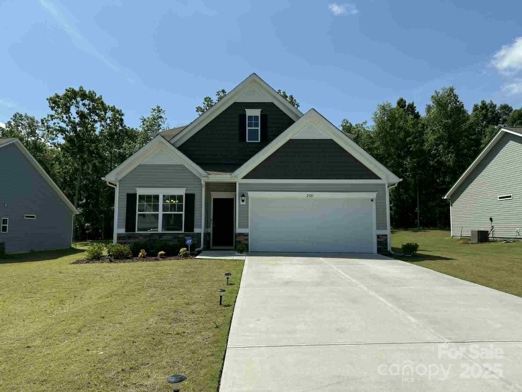 2921 Parkwest Dr, Albemarle, NC 28001 - craftsman inspired home with a front lawn, an attached garage, driveway, and stone siding