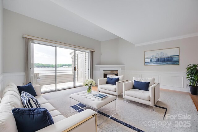 14053 Queens Harbor Rd, Charlotte, NC 28278 - living area with wood finished floors, wainscoting, a fireplace, crown molding, and a decorative wall
