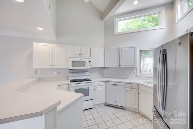 14053 Queens Harbor Rd, Charlotte, NC 28278 - kitchen with white appliances, high vaulted ceiling, a peninsula, light tile patterned floors, and light countertops