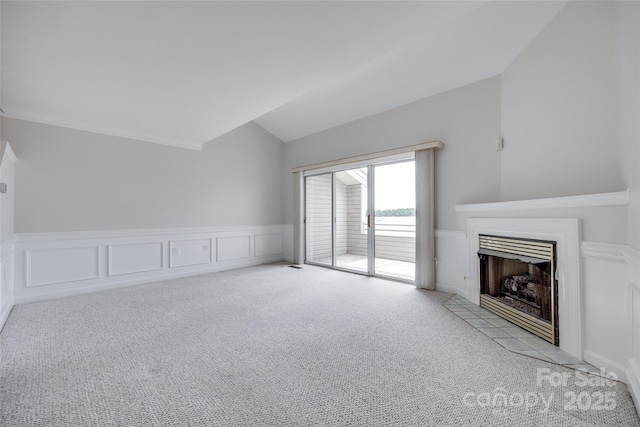 14053 Queens Harbor Rd, Charlotte, NC 28278 - unfurnished living room with lofted ceiling, carpet, a fireplace with flush hearth, a wainscoted wall, and a decorative wall