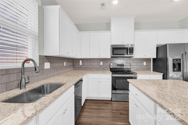 3207 Selwyn Landing Dr, Charlotte, NC 28215 - kitchen featuring stainless steel appliances, white cabinetry, tasteful backsplash, and recessed lighting