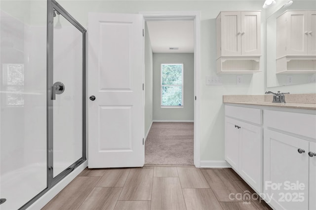 3207 Selwyn Landing Dr, Charlotte, NC 28215 - bathroom with a stall shower, vanity, and wood finished floors