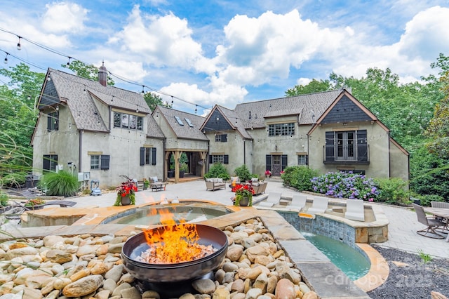 3587 Ridgetop Rd, Sherrills Ford, NC 28673 - rear view of house featuring a fire pit, stucco siding, a patio area, and a shingled roof