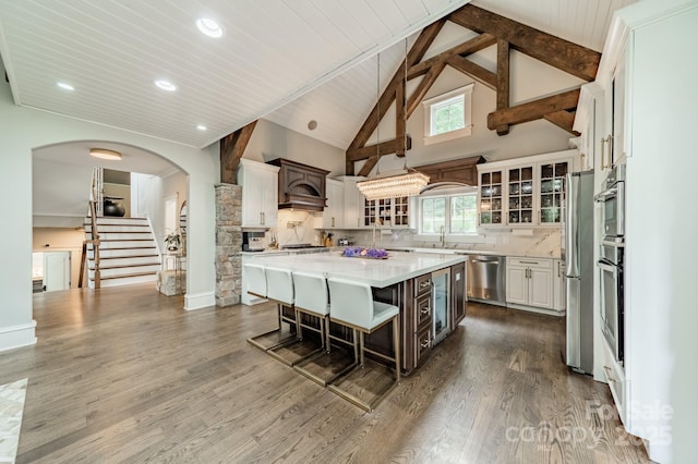 3587 Ridgetop Rd, Sherrills Ford, NC 28673 - kitchen with appliances with stainless steel finishes, a kitchen bar, glass insert cabinets, a center island, and white cabinets