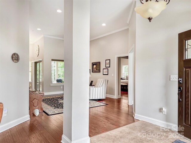 106 Pier Point Dr, Stony Point, NC 28678 - entrance foyer featuring ornamental molding, wood finished floors, a towering ceiling, and recessed lighting