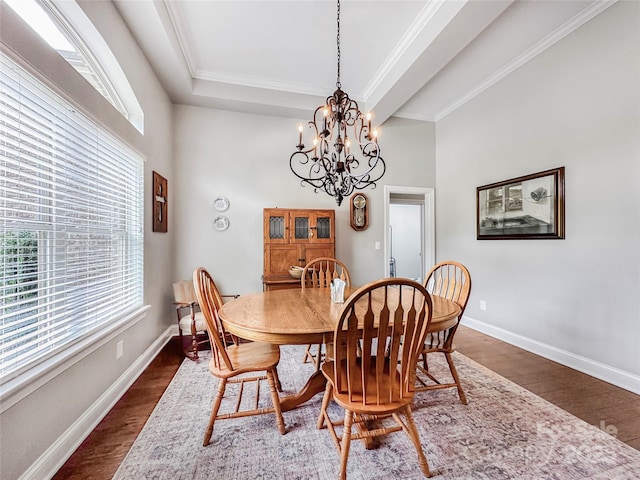 106 Pier Point Dr, Stony Point, NC 28678 - dining room featuring dark wood-type flooring, a chandelier, a towering ceiling, and ornamental molding