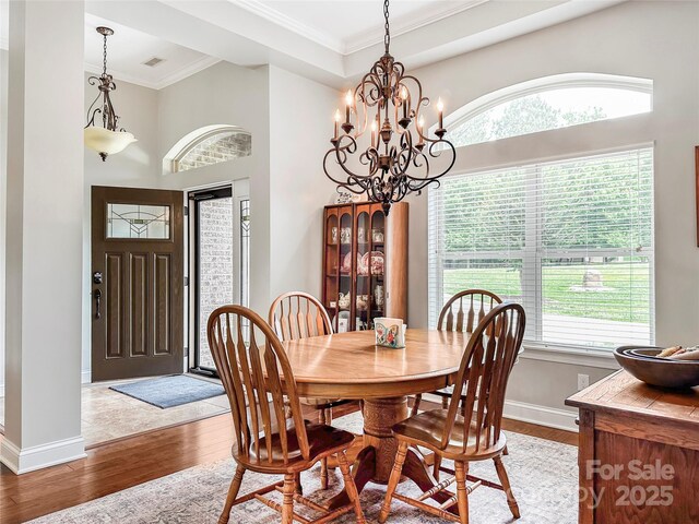 106 Pier Point Dr, Stony Point, NC 28678 - dining room featuring light wood finished floors, a chandelier, ornamental molding, and a towering ceiling