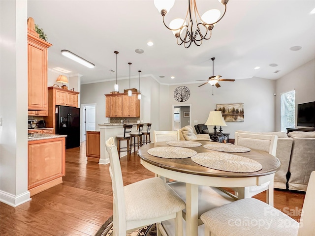 106 Pier Point Dr, Stony Point, NC 28678 - dining space featuring ceiling fan, ornamental molding, light wood finished floors, recessed lighting, and a chandelier