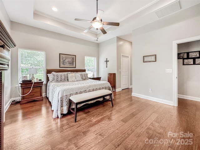 106 Pier Point Dr, Stony Point, NC 28678 - bedroom featuring a raised ceiling, light wood finished floors, multiple windows, and recessed lighting