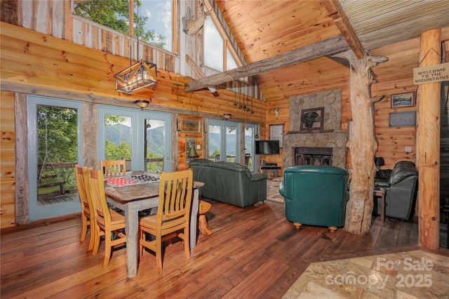 1145 Eagles Roost Rd, Bryson City, NC 28713 - dining room with hardwood / wood-style flooring, french doors, a stone fireplace, high vaulted ceiling, and a wooden ceiling with exposed beams