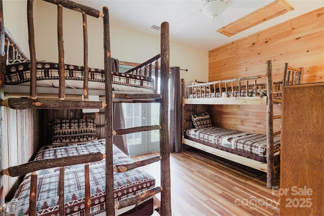 1145 Eagles Roost Rd, Bryson City, NC 28713 - bedroom with wood finished floors and wooden walls