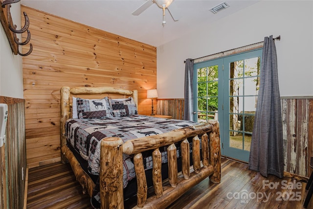 1145 Eagles Roost Rd, Bryson City, NC 28713 - bedroom featuring wooden walls, wood finished floors, access to exterior, wainscoting, and a ceiling fan