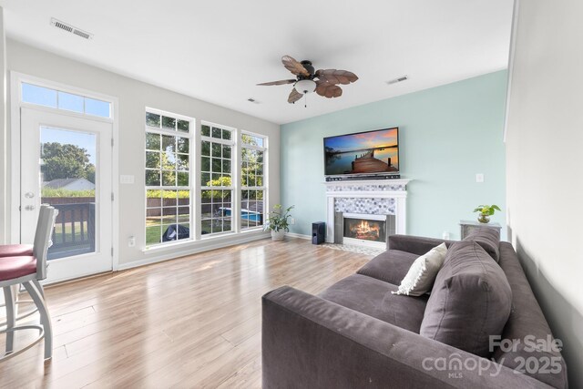 5104 Timbertop Ln, Charlotte, NC 28215 - living area featuring ceiling fan, a tile fireplace, and wood finished floors