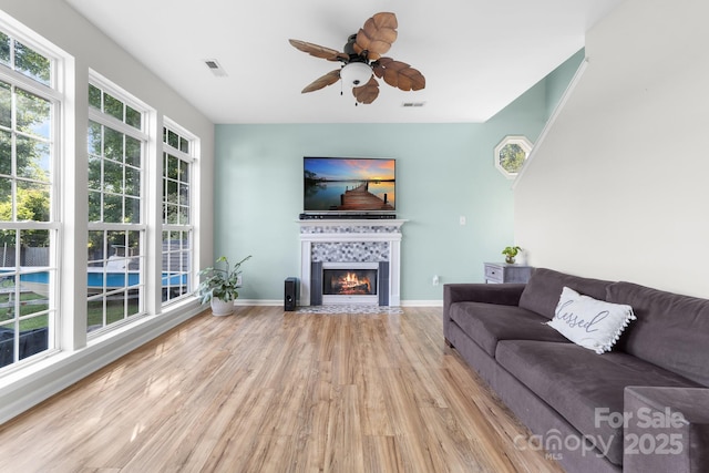 5104 Timbertop Ln, Charlotte, NC 28215 - living room featuring wood finished floors, a ceiling fan, and a tile fireplace