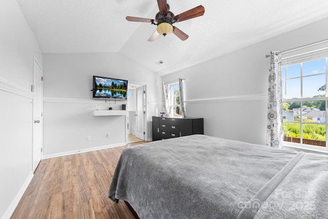 5104 Timbertop Ln, Charlotte, NC 28215 - bedroom featuring multiple windows, wood finished floors, lofted ceiling, and a ceiling fan