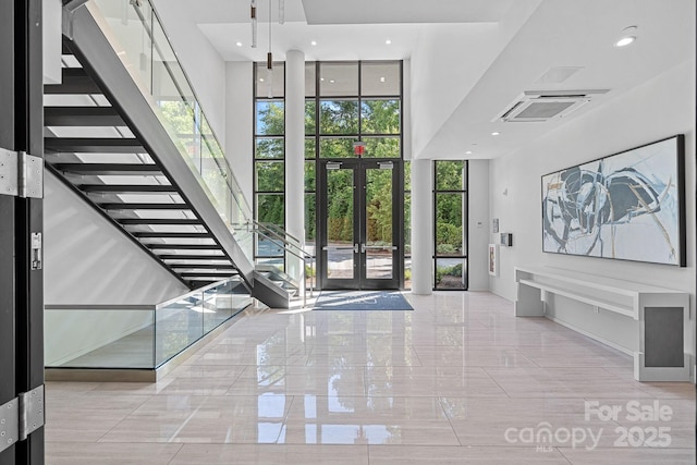 19329 Watermark Dr Unit 422, Cornelius, NC 28031 - entryway featuring french doors, stairs, expansive windows, a high ceiling, and recessed lighting