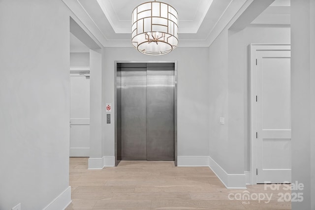 19329 Watermark Dr Unit 422, Cornelius, NC 28031 - foyer entrance featuring elevator, light wood-style flooring, a chandelier, ornamental molding, and a raised ceiling