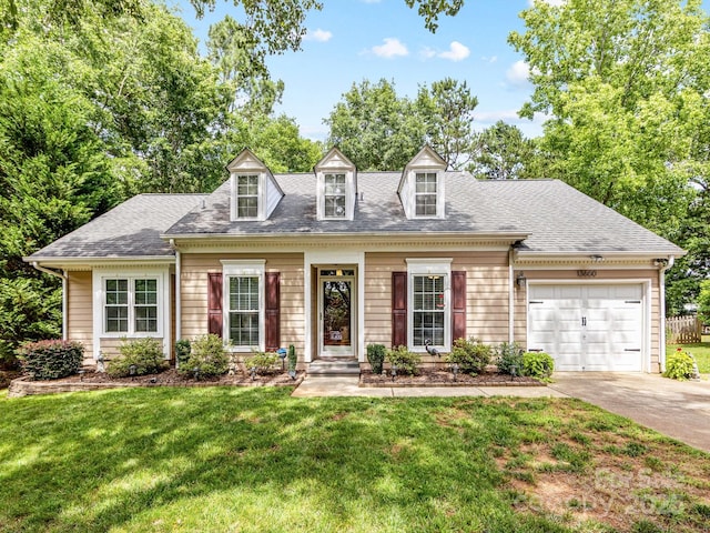 13600 Seastone Ln, Pineville, NC 28134 - cape cod home featuring driveway, a front lawn, an attached garage, and roof with shingles