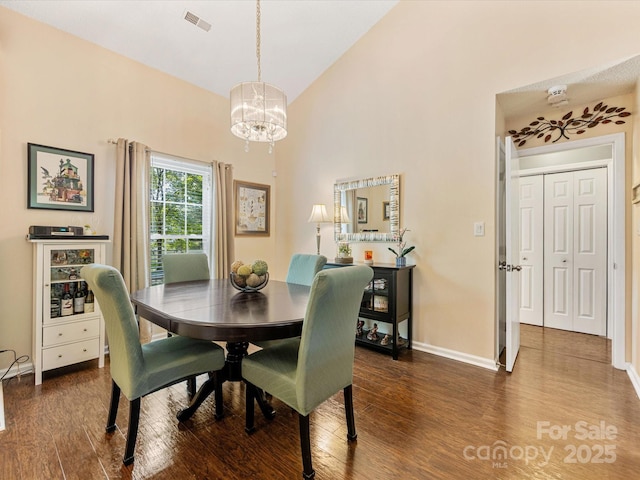 13600 Seastone Ln, Pineville, NC 28134 - dining area featuring a chandelier, dark wood-style floors, and high vaulted ceiling