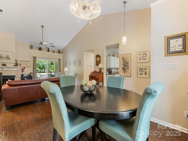 13600 Seastone Ln, Pineville, NC 28134 - dining room featuring high vaulted ceiling, dark wood-type flooring, ceiling fan, a fireplace, and a chandelier