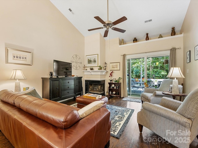 13600 Seastone Ln, Pineville, NC 28134 - living area featuring high vaulted ceiling, ceiling fan, dark wood-type flooring, and a glass covered fireplace