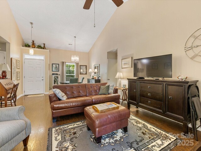 13600 Seastone Ln, Pineville, NC 28134 - living room with dark wood-type flooring, high vaulted ceiling, a chandelier, and ceiling fan