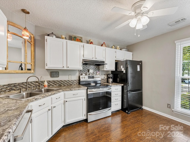 13600 Seastone Ln, Pineville, NC 28134 - kitchen featuring appliances with stainless steel finishes, under cabinet range hood, a textured ceiling, backsplash, and dark wood-style flooring