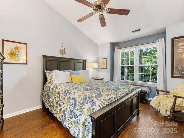 13600 Seastone Ln, Pineville, NC 28134 - bedroom with dark wood-type flooring, vaulted ceiling, a textured ceiling, and a ceiling fan