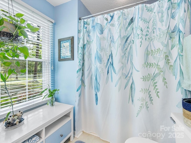 13600 Seastone Ln, Pineville, NC 28134 - bathroom featuring a textured ceiling, a shower with shower curtain, and tile patterned floors